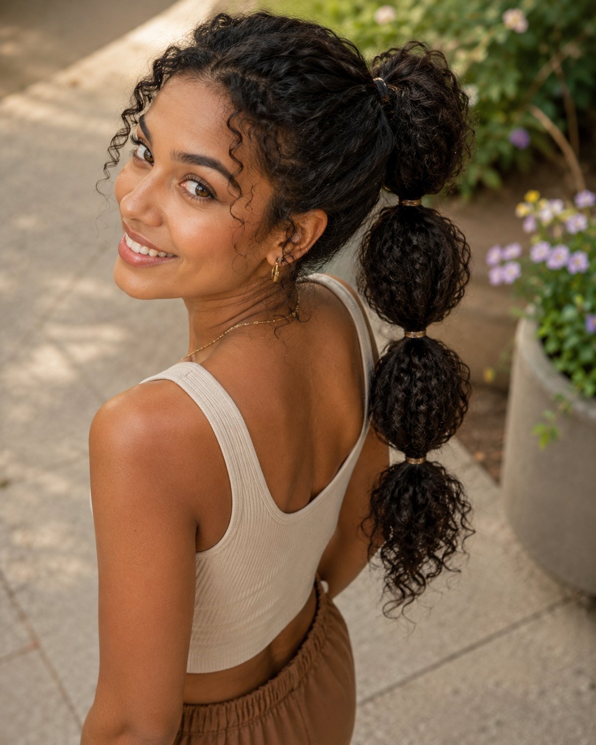 Bubble ponytail for thick curly long hair — playful segmented textured style
