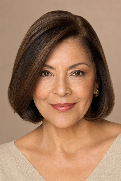 Woman over 50 with a classic short bob at the jawline featuring a deep side part creating asymmetry and face-flattering lines
