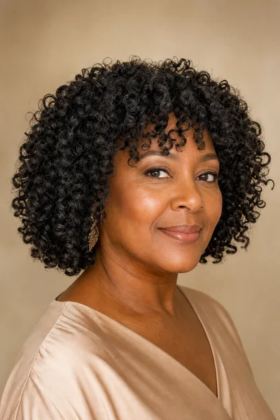 35 Short Haircuts for Black Women Over 50 That Look Stunning in 2026 20 Curly bob for natural texture for Black women over 50 — loose 4a curls, cut for shrinkage, jaw-length when curly