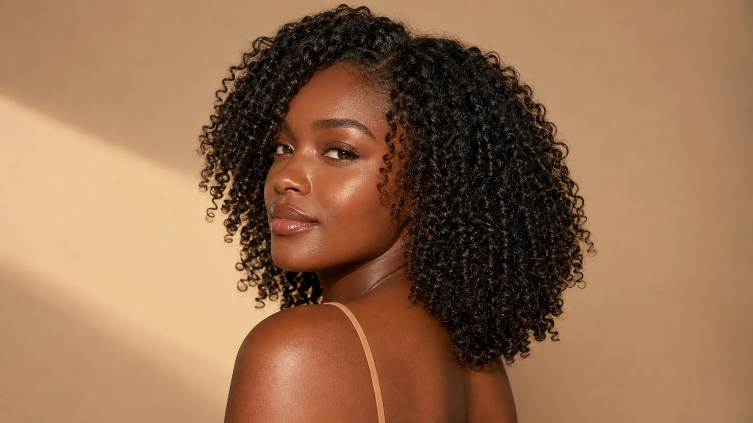 20 Stunning Curly Hairstyles for Women With Natural Hair in 2026 4 Black woman with shoulder-length type 4 coils showing defined curl pattern, medium-length natural curly hairstyle