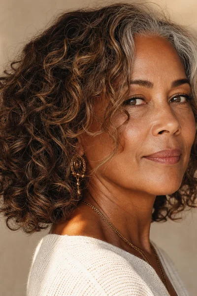 25 Short Curly Haircuts for Women Over 50 That Look Effortlessly Chic 7 curly lob with face-framing layers for women over 50 — softening layered haircut