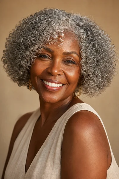 curly silver bob haircut for round faces — natural curls form soft rounded shape at bob length