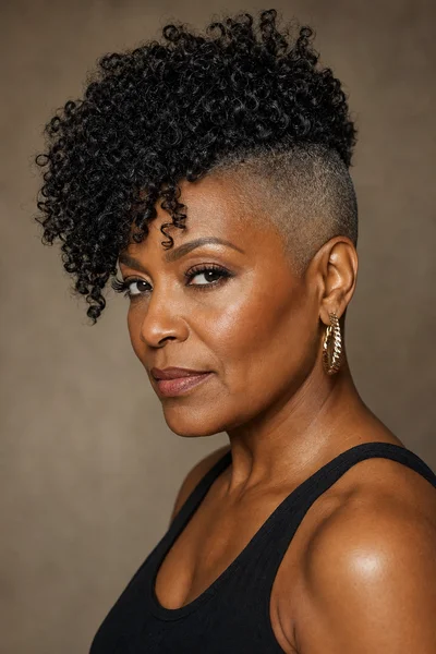 35 Short Haircuts for Black Women Over 50 That Look Stunning in 2026 32 Curly undercut for Black women over 50 — loose 4a curls on top, shaved sides, squares face flattering