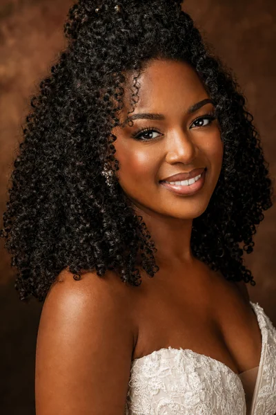 Half-up wedding hairstyle with natural curls and minimal pins — effortless bridal style for curly to coily hair with square and oval faces