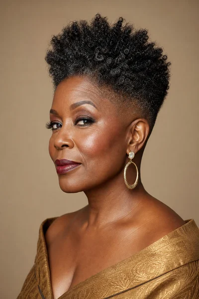 35 Short Haircuts for Black Women Over 50 That Look Stunning in 2026 34 High-top curly fade for Black women over 50 — dramatic height, 4b curls on top, faded sides, heart face flattering