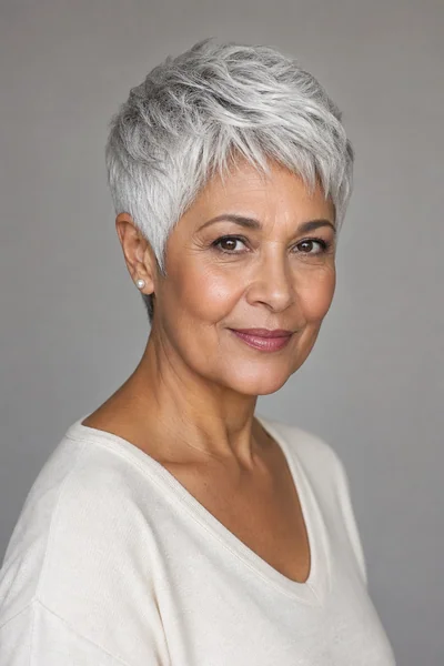 Short gray pixie with close-cropped sides on thick hair — mature women's short haircut