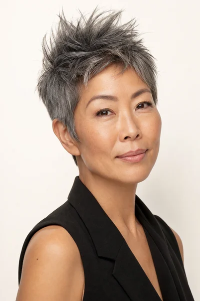12 Short Gray Pixie Cuts for Women Over 50 6 Modern spiky gray pixie cut with textured layers on Asian woman over 50
