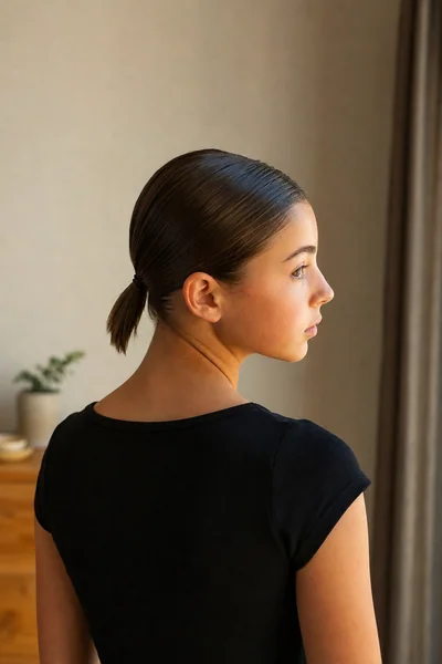 Slicked-back low ponytail on shoulder-length lob hair for school
