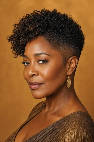 35 Short Haircuts for Black Women Over 50 That Look Stunning in 2026 13 Tapered cut with natural curl top — tapered sides with full 4b curls on top, heart face flattering