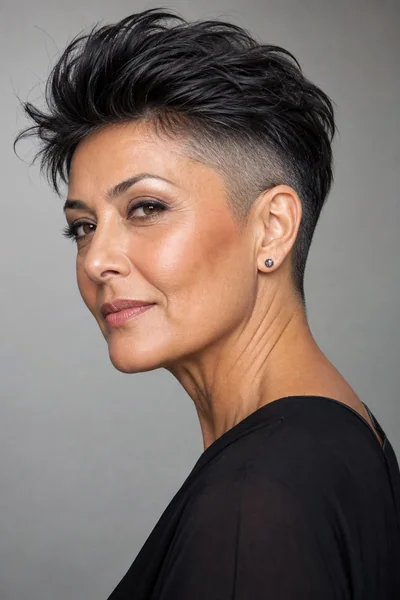 Undercut pixie with clippered underlayer on thick hair — bold short haircut for mature women