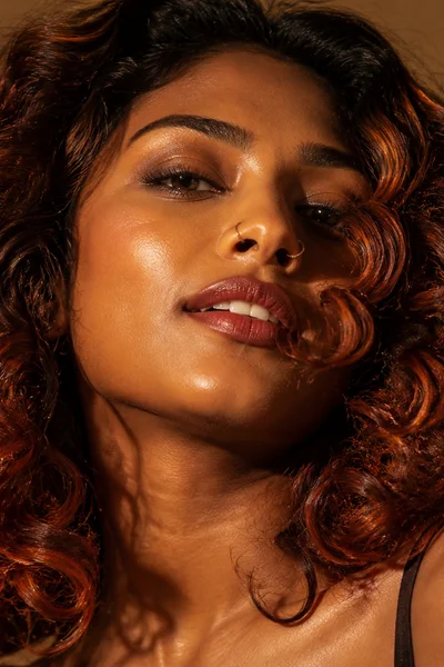 Auburn hair color on curly hair — rich warm red-brown shade for textured hair