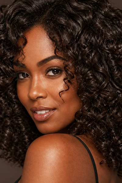 Cool chocolate brown on curly hair — glossy low-maintenance brown for textured hair