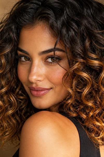 Chocolate to caramel ombre on curly hair — forgiving low-maintenance gradient color
