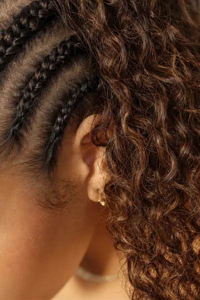 20 Goddess Braids That Make a Statement 3 close-up detail of goddess braid cornrow base transitioning into curly loose ends