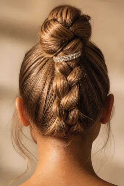 high braided ponytail bun prom updo — modern youthful hairstyle