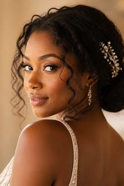 romantic low chignon prom updo with loose curls — soft hairstyle for prom