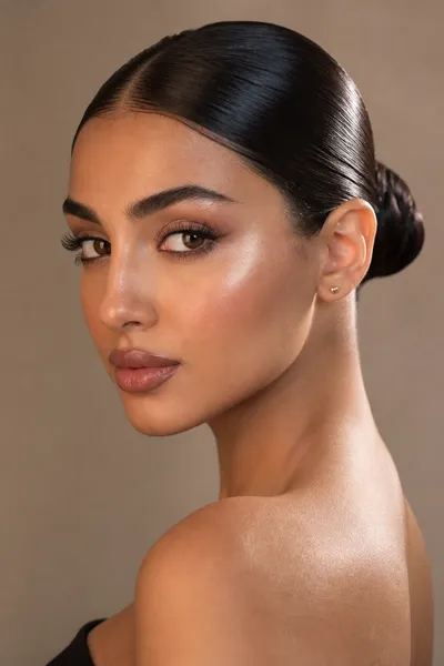 Wet-look slicked-back bun — minimalist, glossy prom updo for oval and heart-shaped faces