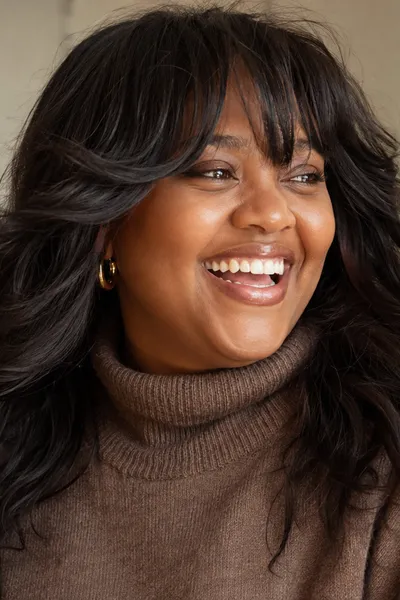Bottleneck Bangs: The New Trend to Try This Year 8 bottleneck bangs styled for a round face shape and wavy hair texture