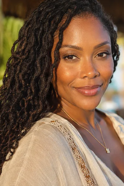 Braid-out loc hairstyle, soft wave texture for beach vacation and humid climates