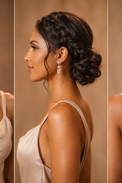 Woman with braided low bun for wedding or gala in warm studio lighting