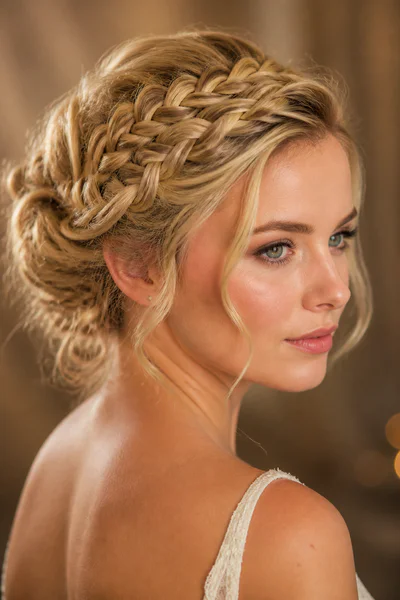 Braided updo for curly hair, one of these homecoming hair ideas for curly and textured hair