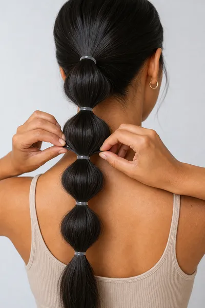 12 Bubble Bun Hairstyles That Are Trending This Year 2 Step-by-step bubble bun technique showing elastic placement and sectioning.