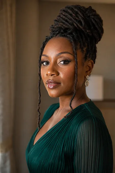 High bun with face-framing loc hairstyle, softens square and heart face shapes