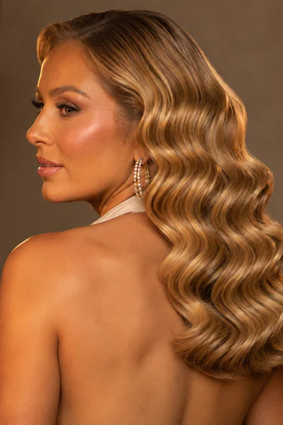 Woman with Hollywood waves showing deep S-shaped curls in warm studio lighting