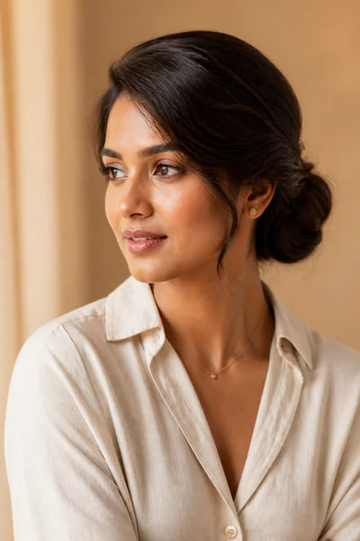 Low bun with soft side part, softening style for square faces