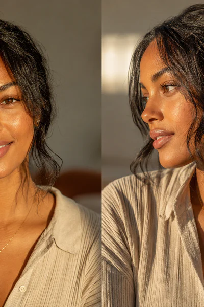 Woman with textured low ponytail and soft face-framing pieces in warm golden light